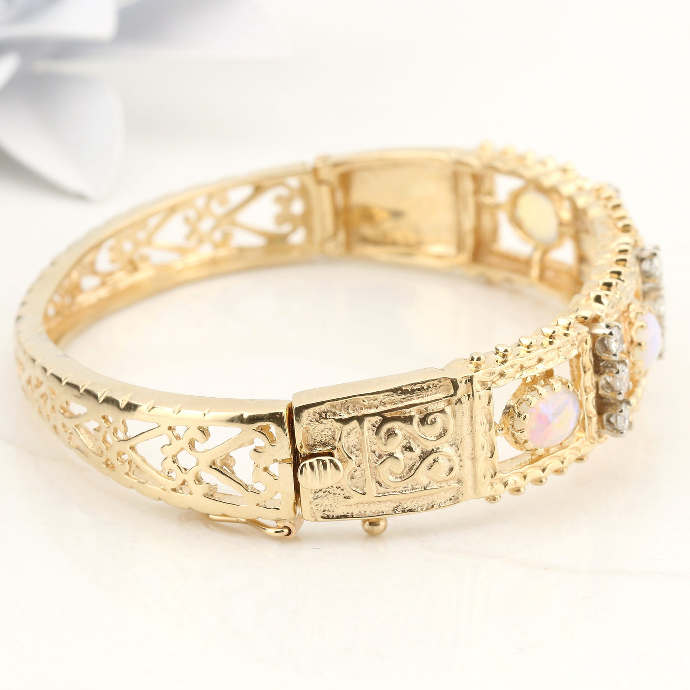 Yellow gold bangle with diamonds and opals